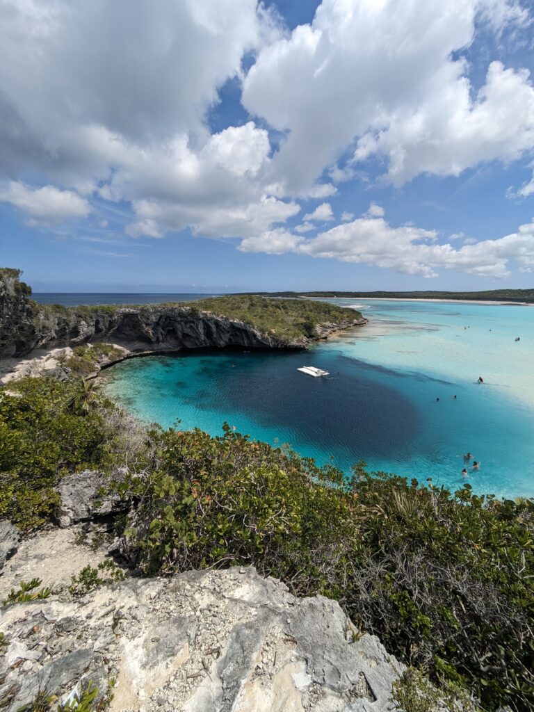 Looking at Deans blue hole from above. A circle of dark blue water surrounded by a ring of turquoise then a ring of  light blue