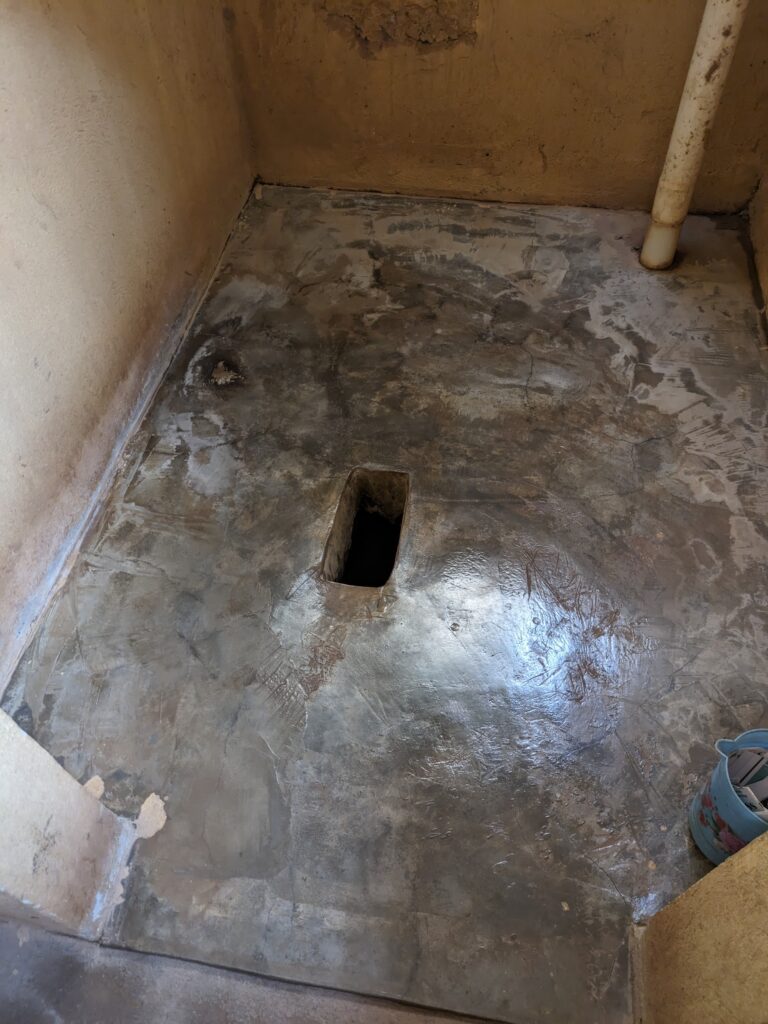 A hole in the floor is a bathroom that we used on our safari drive.